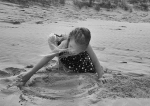 Girl playing in the sand