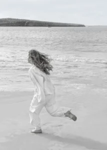 girl-running-along -the-beach