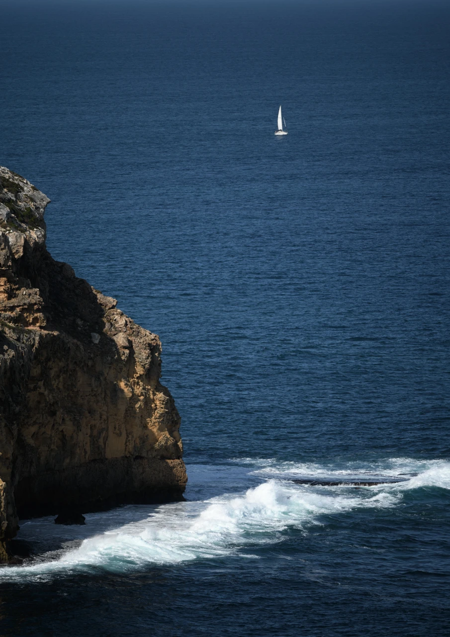 Yacht sails around Cape Spencer