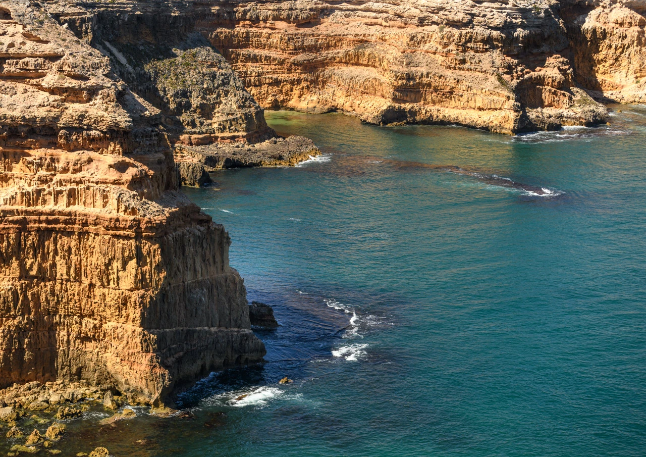 Cliffs around Cape Spencer very green sea water