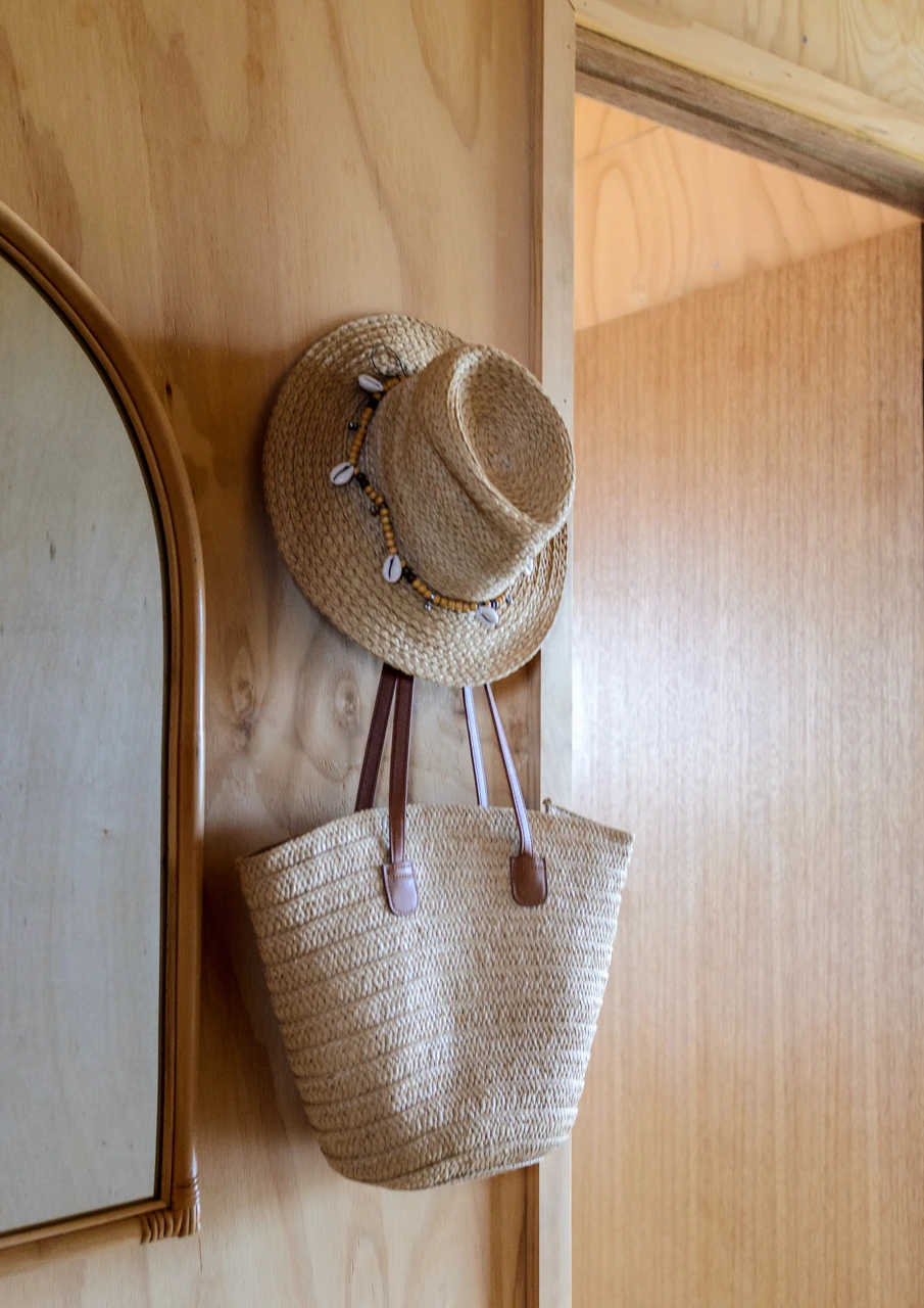 Sun hats hang up at the holiday house