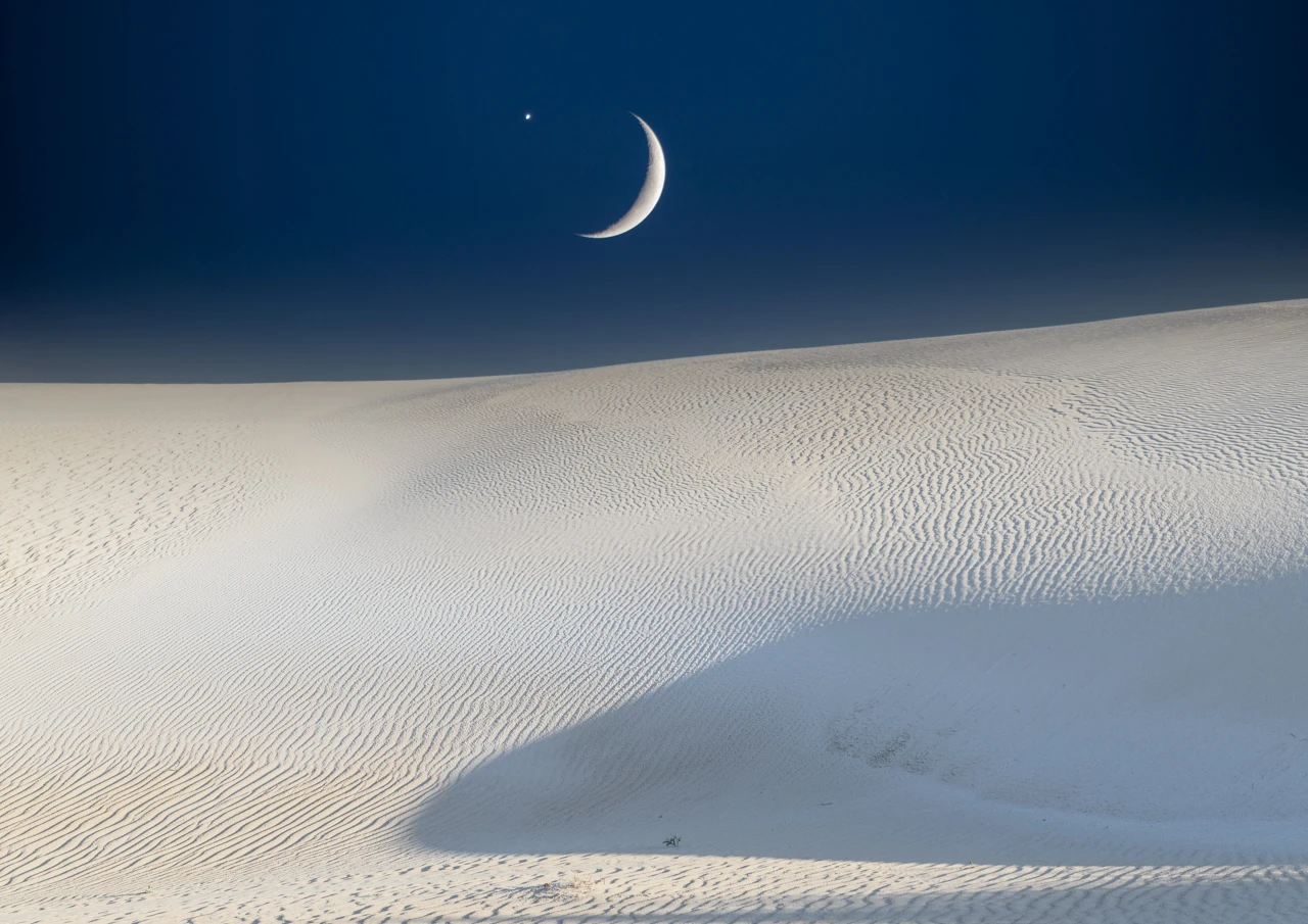 Moon and star and white sand dunes