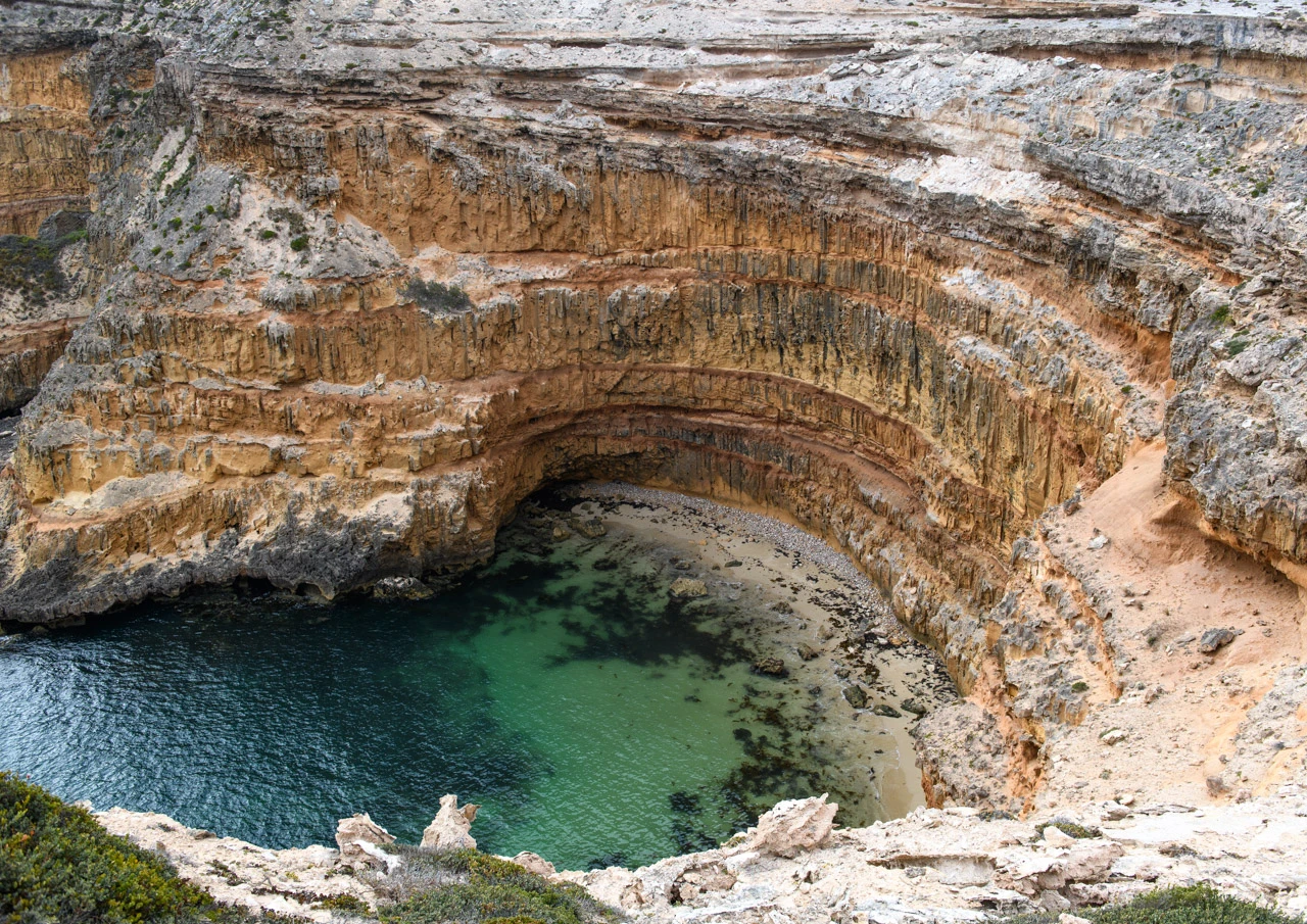 Looking down steep cliff faces and ocean below