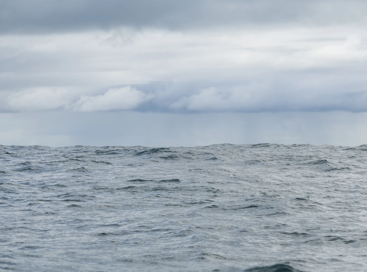 Cloudy skies and a light blue ocean