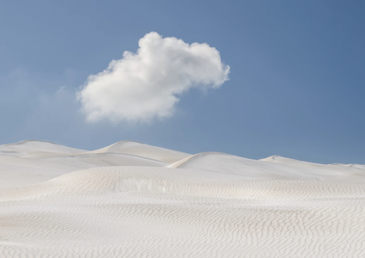 White sand dunes and lonely cloud